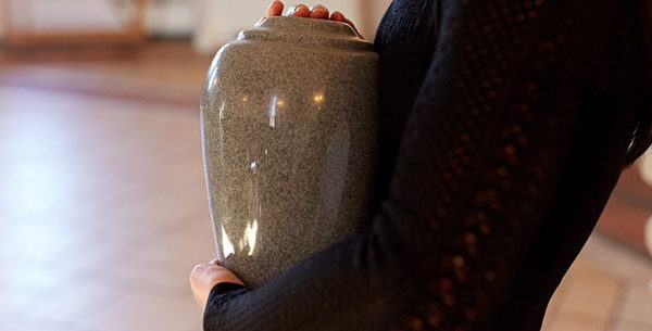 Person carrying an urn