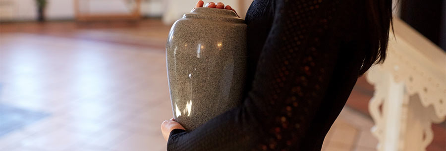 Person carrying an urn